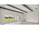 Spacious living room with wood beams and large sliding doors leading to outdoor space at 14279 Swiss Bridge Dr, Riverview, FL 33579