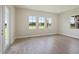 Open floor plan features light wood floors and large windows with backyard views at 14279 Swiss Bridge Dr, Riverview, FL 33579