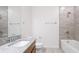 Modern bathroom showcasing a granite vanity, and stylish tiled shower and tub at 14424 59Th E Cir, Bradenton, FL 34211