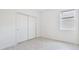 Bright bedroom featuring wood-look floors, window, and sliding door closet at 14424 59Th E Cir, Bradenton, FL 34211
