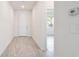 Clean, bright hallway with white walls and light wood-look floors, leading to other parts of the home at 14424 59Th E Cir, Bradenton, FL 34211