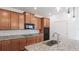 Kitchen with stainless steel appliances, granite counters and wood cabinets at 14424 59Th E Cir, Bradenton, FL 34211
