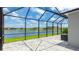 Screened lanai with beautiful pavers offering stunning views of the pond, blue sky, and lovely neighborhood homes at 14424 59Th E Cir, Bradenton, FL 34211