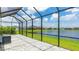 The screened lanai with stone pavers offers beautiful pond views, complemented by serene views of houses in the neighborhood at 14424 59Th E Cir, Bradenton, FL 34211