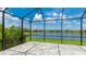 Screened lanai offering stunning views of the pond, blue sky, and beautiful neighborhood houses at 14424 59Th E Cir, Bradenton, FL 34211