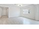 Bright living room features wood-look floors and a window letting in natural light at 14424 59Th E Cir, Bradenton, FL 34211