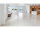 Open-concept living room with modern finishes, seamlessly connecting the kitchen, dining, and living areas with an expansive lake view at 14424 59Th E Cir, Bradenton, FL 34211