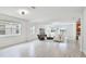 Bright living area with wood floors, modern furniture, light fixtures, and large windows that give ample natural light at 14424 59Th E Cir, Bradenton, FL 34211