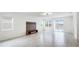 Spacious living room with a modern entertainment center and sliding glass doors to the screened patio at 14424 59Th E Cir, Bradenton, FL 34211