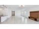 Open-concept living and kitchen area with modern lighting, granite countertops, and wood-look floors at 14424 59Th E Cir, Bradenton, FL 34211
