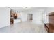 Open-concept kitchen and living area with granite counters, wood cabinets, and wood-look floors at 14424 59Th E Cir, Bradenton, FL 34211