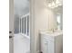 Modern bathroom with white cabinets, sink, mirror, and a door leading to the outside at 14523 Swiss Bridge Dr, Lithia, FL 33547