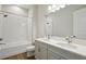 Bright bathroom with tiled floors, double vanity, and shower over tub at 14523 Swiss Bridge Dr, Lithia, FL 33547