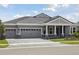 Charming home with a large three car garage, a grey stone driveway, and attractive architectural details at 14523 Swiss Bridge Dr, Lithia, FL 33547