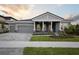 Charming home with a beautifully landscaped front yard and an attached three-car garage at 14523 Swiss Bridge Dr, Lithia, FL 33547