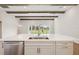Modern kitchen boasts an island with a marble countertop, ample white cabinetry, and stainless steel appliances at 14523 Swiss Bridge Dr, Lithia, FL 33547