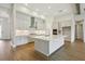 Modern kitchen boasts an island with a marble countertop, ample white cabinetry, and stainless steel appliances at 14523 Swiss Bridge Dr, Lithia, FL 33547