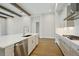 Modern kitchen boasts an island with a marble countertop, ample white cabinetry, and stainless steel appliances at 14523 Swiss Bridge Dr, Lithia, FL 33547