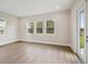 Bright living room showcasing hardwood floors, large windows providing natural light at 14523 Swiss Bridge Dr, Lithia, FL 33547
