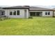 Expansive backyard with large grass area, patio, and ample natural light at 14531 Swiss Bridge Dr, Lithia, FL 33547