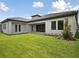 Spacious backyard with lush green grass and a covered patio area at 14531 Swiss Bridge Dr, Lithia, FL 33547