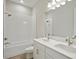 Bright bathroom featuring a double vanity, white cabinets and a tiled shower and tub at 14531 Swiss Bridge Dr, Lithia, FL 33547