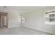 Spacious bedroom with neutral carpet, trim, and paint, plus multiple windows for natural light at 14531 Swiss Bridge Dr, Lithia, FL 33547