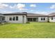 Expansive backyard, patio, and an exterior view of the home with modern design at 14531 Swiss Bridge Dr, Lithia, FL 33547