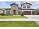Charming two-story home with brick accents, wood garage doors, and manicured landscaping in a suburban neighborhood at 14531 Swiss Bridge Dr, Lithia, FL 33547
