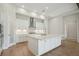 Bright kitchen featuring white cabinetry, a large island, and stainless steel appliances at 14531 Swiss Bridge Dr, Lithia, FL 33547
