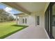 Covered patio perfect for entertaining with an outdoor kitchen, lush lawn and backyard at 14531 Swiss Bridge Dr, Lithia, FL 33547