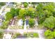 An aerial view of the property showing the house, surrounding trees, and the neighborhood at 1510 Mobile Ave, Tampa, FL 33610