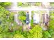 An aerial view shows the property's layout, with a nice backyard and mature trees offering shade and privacy at 1510 Mobile Ave, Tampa, FL 33610