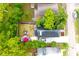 This bird's-eye perspective highlights the cozy backyard, complete with patio furniture and privacy from mature trees at 1510 Mobile Ave, Tampa, FL 33610