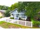 Charming home with a well-kept lawn and a classic white picket fence at 1510 Mobile Ave, Tampa, FL 33610