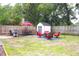 Spacious backyard featuring a shed, lawn, outdoor seating areas, and a wood privacy fence at 1510 Mobile Ave, Tampa, FL 33610