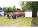Backyard featuring a shed, patio furniture, a grill, and a privacy fence, perfect for outdoor living at 1510 Mobile Ave, Tampa, FL 33610