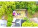 Aerial view of the backyard featuring an inviting outdoor space with a fire pit, seating, and a pink umbrella at 1510 Mobile Ave, Tampa, FL 33610