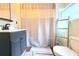 Bathroom features a ladder, shower curtain, and gray vanity at 1510 Mobile Ave, Tampa, FL 33610