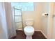 Bright bathroom with a toilet, a ladder for towels, and a small window bringing in natural light at 1510 Mobile Ave, Tampa, FL 33610