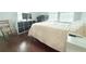 Bedroom with dark wood floors, two windows, and desk space at 1510 Mobile Ave, Tampa, FL 33610