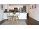 Modern dining area with a glass table and stylish chairs adjoining the kitchen at 1510 Mobile Ave, Tampa, FL 33610