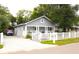 Beautifully renovated home with a paved driveway and a charming picket fence at 1510 Mobile Ave, Tampa, FL 33610