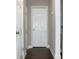 Hallway with multiple doors and wood flooring at 1510 Mobile Ave, Tampa, FL 33610