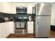 Well-equipped kitchen featuring stainless steel appliances, black countertops, and modern fixtures at 1510 Mobile Ave, Tampa, FL 33610