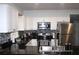 Modern kitchen featuring white cabinets, stainless steel appliances, and dark countertops at 1510 Mobile Ave, Tampa, FL 33610