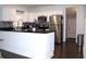 Updated kitchen with stainless steel appliances, black countertops and breakfast bar area at 1510 Mobile Ave, Tampa, FL 33610