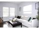 Bright living room with a white couch, dark wood floors, and plenty of natural light at 1510 Mobile Ave, Tampa, FL 33610