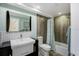 Well-lit bathroom showcasing a modern vanity, decorative tile backsplash, and tub with shower at 1581 Gulf Blvd # 701N, Clearwater Beach, FL 33767
