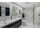 Modern bathroom featuring double sinks, custom tiling, and a glass-enclosed shower with rain showerhead at 1581 Gulf Blvd # 701N, Clearwater Beach, FL 33767
